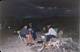 Some members around a camp fire at Bluff Creek